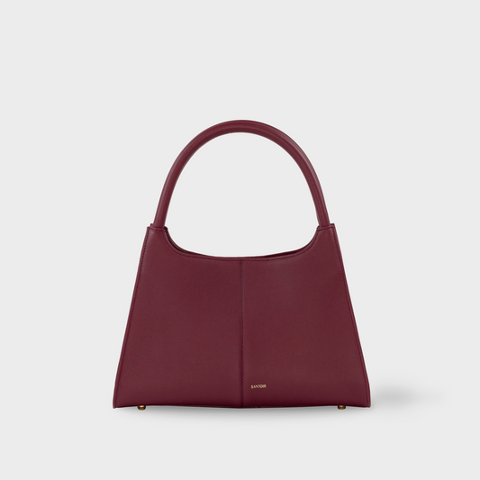Bordeaux semi structured top handle bag in buttery soft smooth calf leather, deep red designer handbag by Santoir with minimalist silhouette, made in Spain.