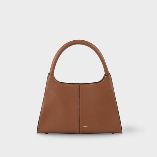 Caramel brown semi structured top handle bag in premium smooth calf leather, buttery soft leather, minimalist and elegant designer handbag by Santoir, made in Spain.