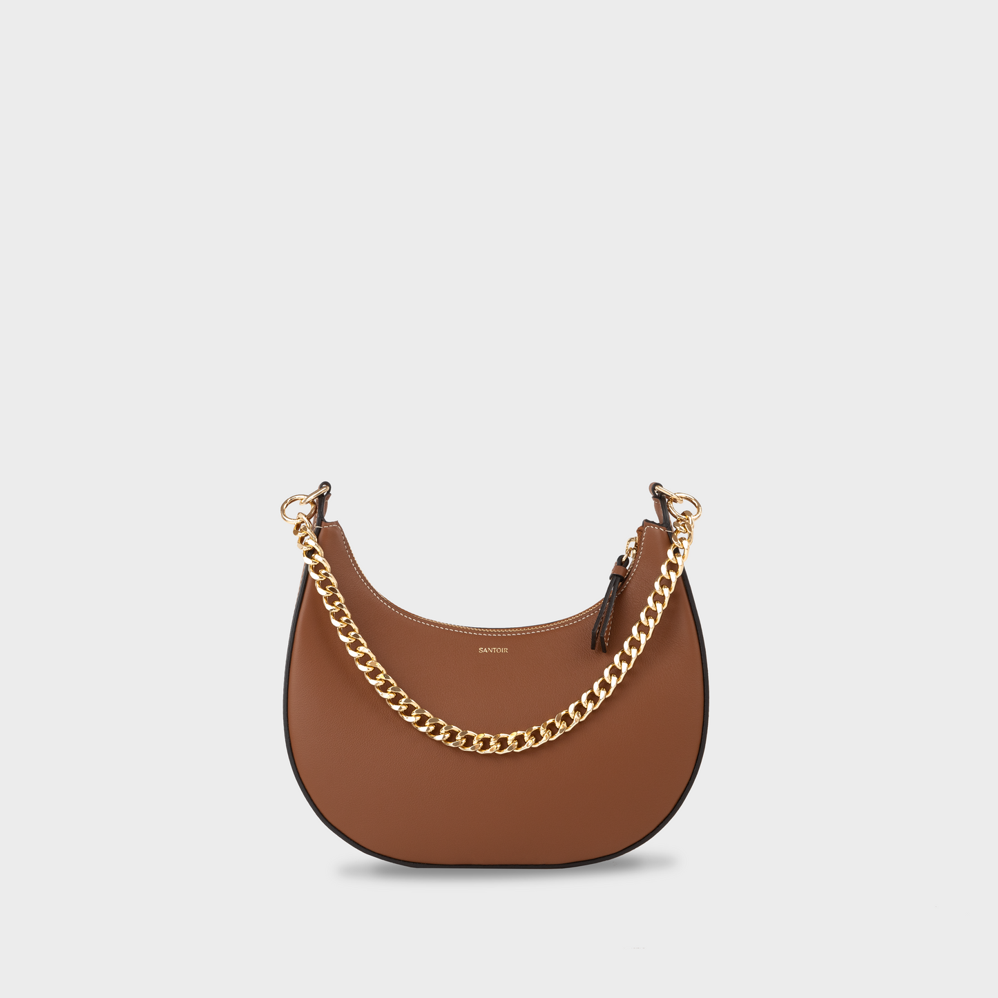 Caramel crescent moon handbag with gold chain strap, Santoir Luna bag in smooth warm tan leather, convertible from daytime wear to elegant evening bag, made in Spain.