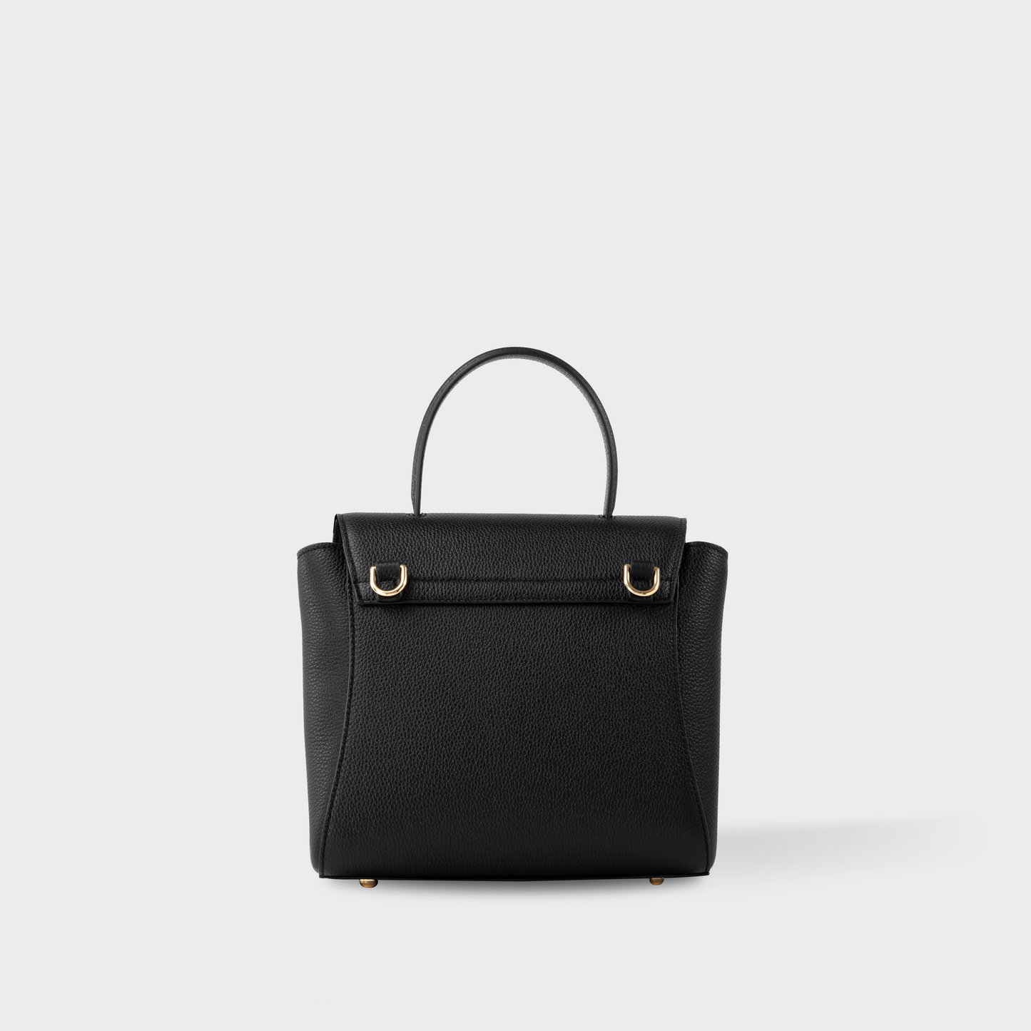 Back view of Mini Boss bag in black pebbled calfskin, compact structured mini handbag with top handle and gold-tone hardware, handcrafted in Spain.