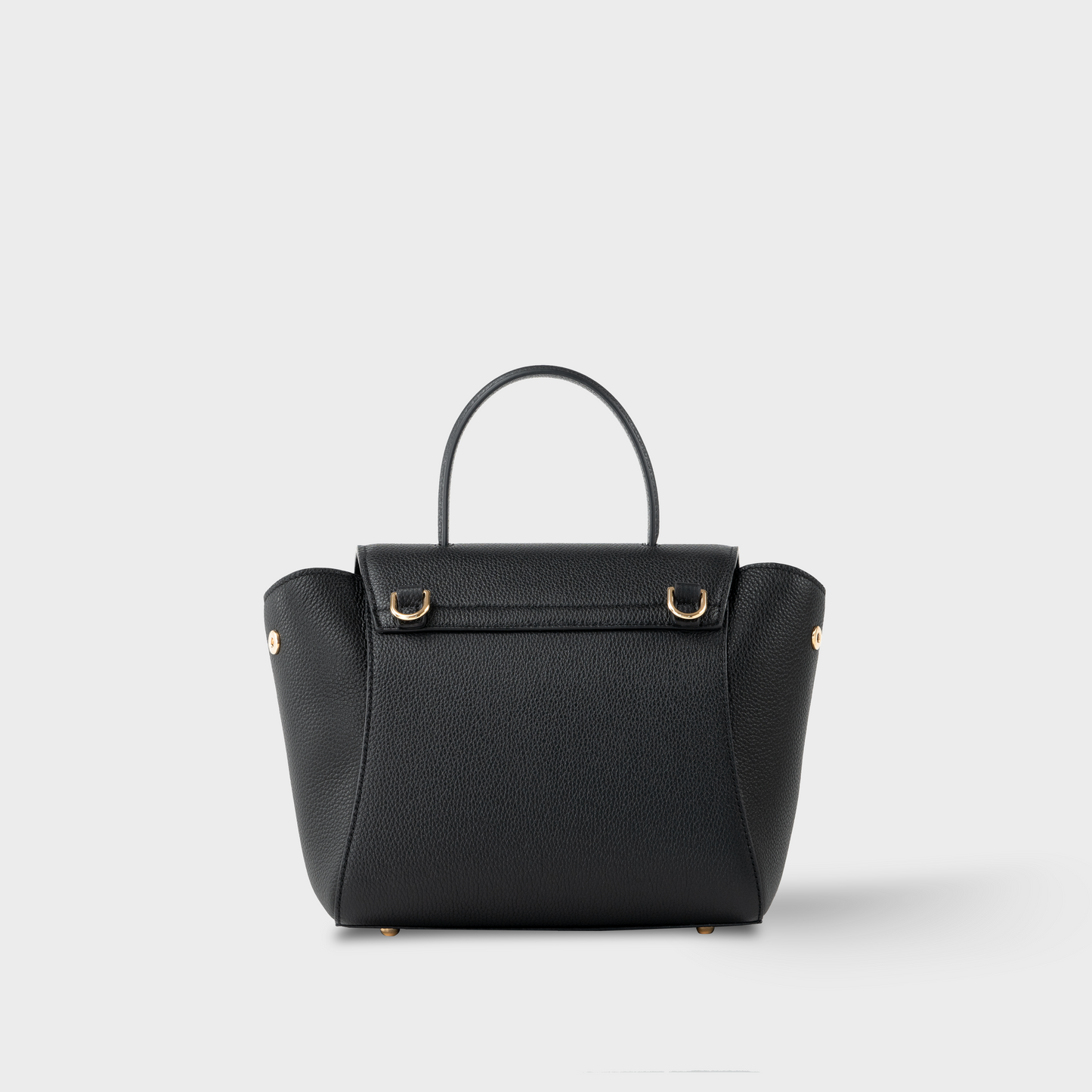 Back view of Mini Boss bag in black pebbled calfskin, compact structured mini handbag with top handle and gold-tone hardware, handcrafted in Spain.