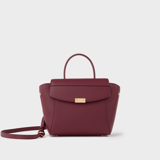 Bordeaux leather mini top handle bag in pebbled calfskin, Santoir Mini Boss with structured silhouette, gold-tone hardware, and minimalist design, handcrafted in Spain.